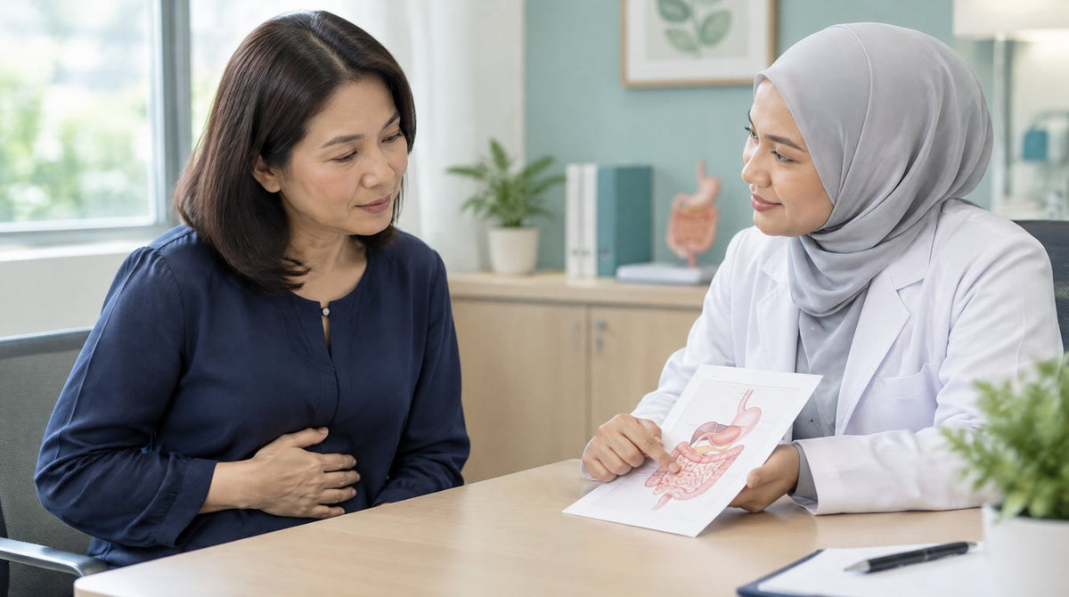 A doctor explaining a digestive system leaflet to a woman in a clinic