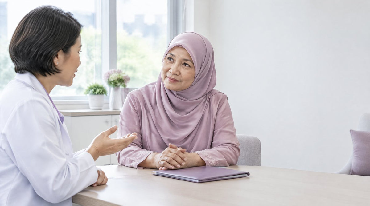 A gynaecologist talking calmly with an older woman in a bright clinic