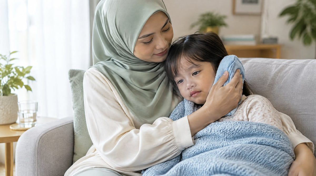 A mother holding a warm towel to her young daughter ear on a sofa