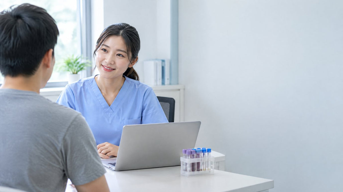 A nurse talking discreetly with a young patient in a private clinic